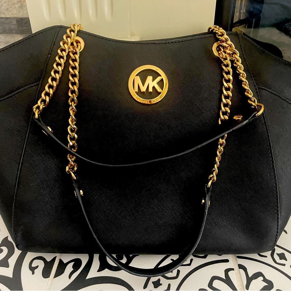 Beautiful like new Michael Kors black shoulder purse with gold chain accents.